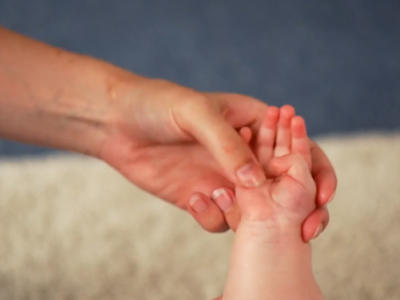 Baby hand being massaged