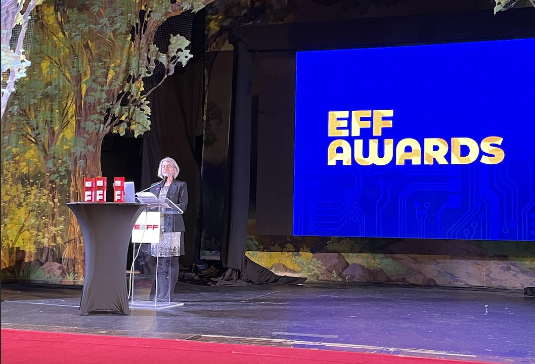 A photo of Cindy Cohn on the stage, with a backdrop that says "EFF Awards" 