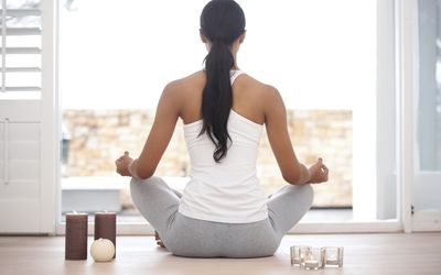 A woman meditating at home