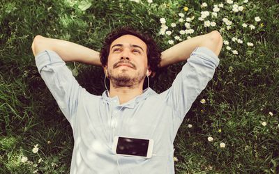Man lying in grass meditating