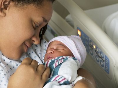 mother cradling newborn son in hospital