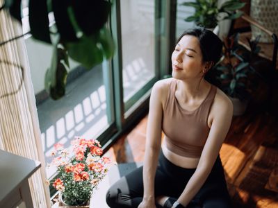 Active young sports woman taking a break after working out at home