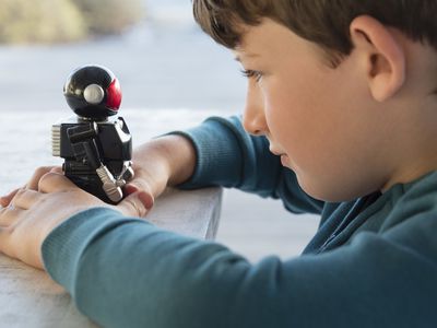 young boy holds robot 