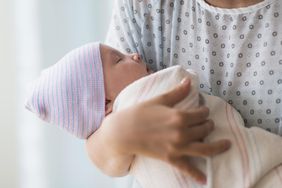 mother holding newborn baby in hospital