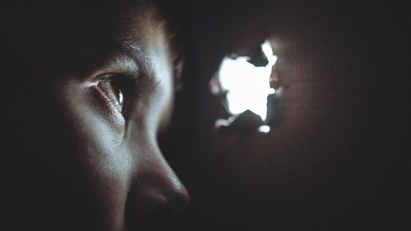 person watching through hole