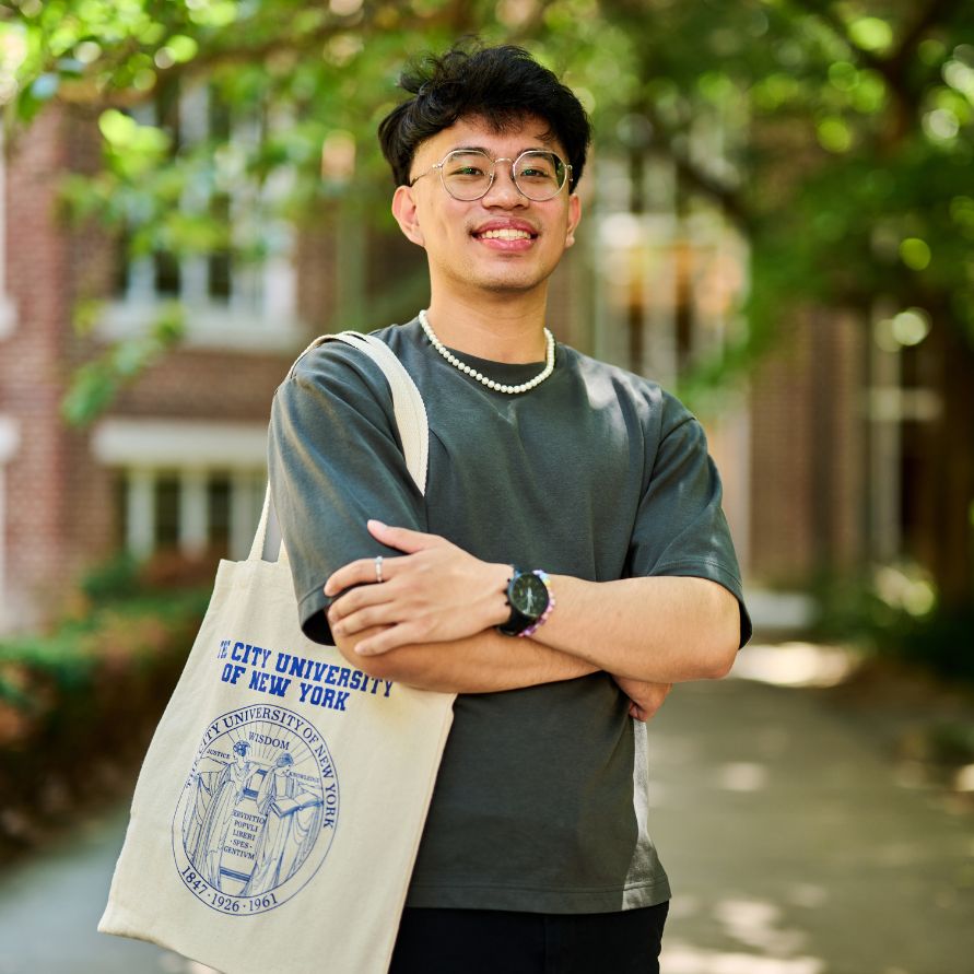 A student holding a CUNY tote bag.