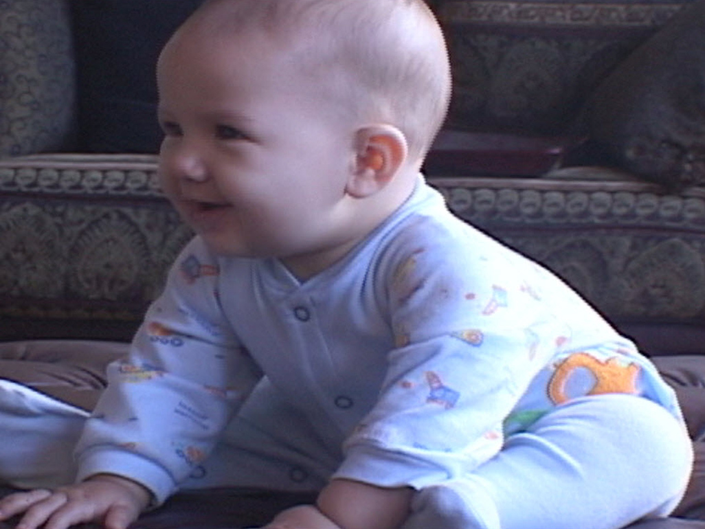 smiling baby sitting in pajamas