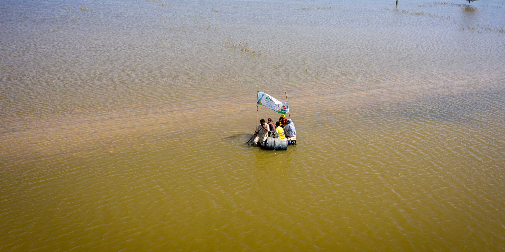 A vaccination team going on a boat (locally made with plastic barrels) to vaccinate children against Typhoid, during the TCV campaign in Sohbatpur city. Credit: Gavi/Asad Zaidi