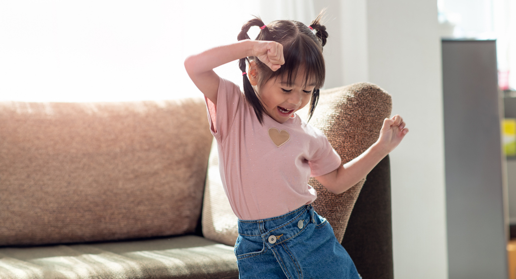 young girl dancing in her living room