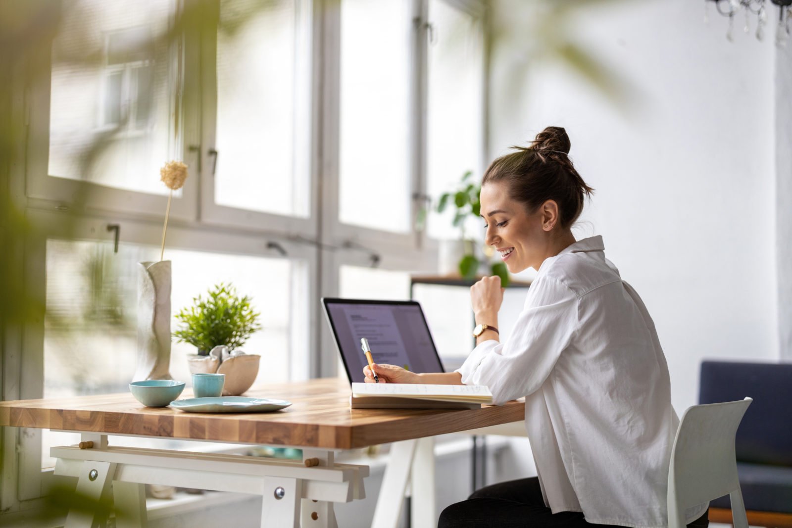 nonprofit website templates: woman sitting at a desk working on her laptop