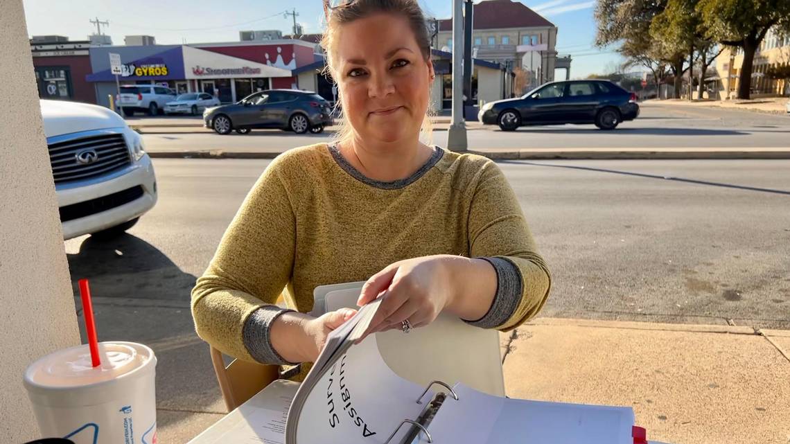 Holly Plemmons, a Fort Worth parent that has been questioning the school over surveys given to students shows a binder she has compiled on the topic, including every survey given to students in a year.