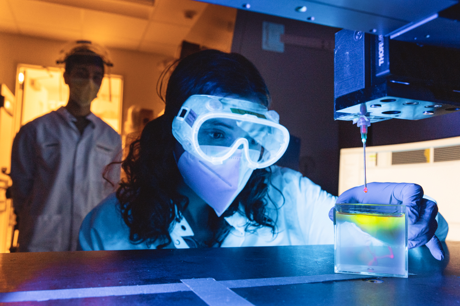 A scientist analyzes an experiment using UV light