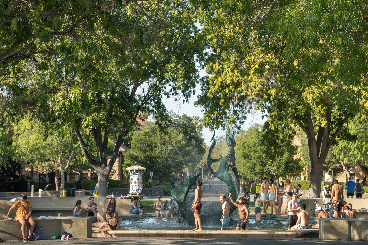 Students splash around in the Claw on a hot day