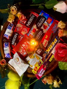 A gift basket full of chocolates and candies.