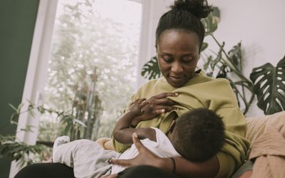 Black mother breastfeeding her child