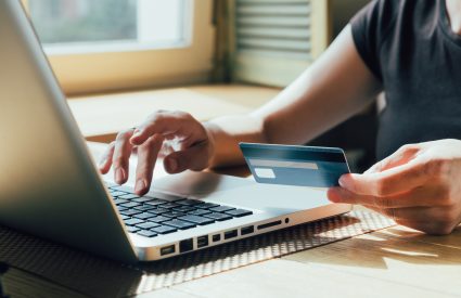 woman shopping with a credit card on a laptop