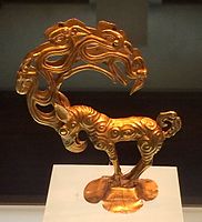 Gold stag with eagle's head, and ten further heads in the antlers. An object inspired by the art of the Siberian Altai mountain, possibly Pazyryk, unearthed at the site of Nalinggaotu, Shenmu County, near Xi'an, China.[100] Possibly from the "Hun people who lived in the prairie in Northern China". Dated to the 4th-3rd century BCE,[100] or Han Dynasty period.[101] Shaanxi History Museum.[101]