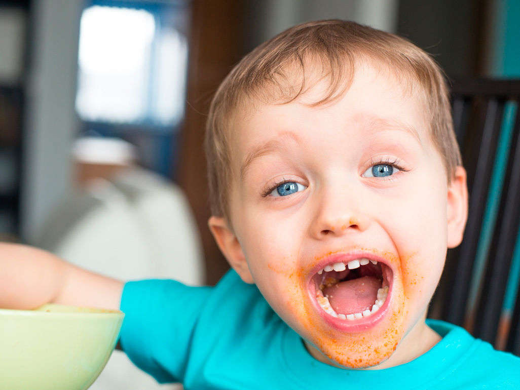 boy eating food in a messy way