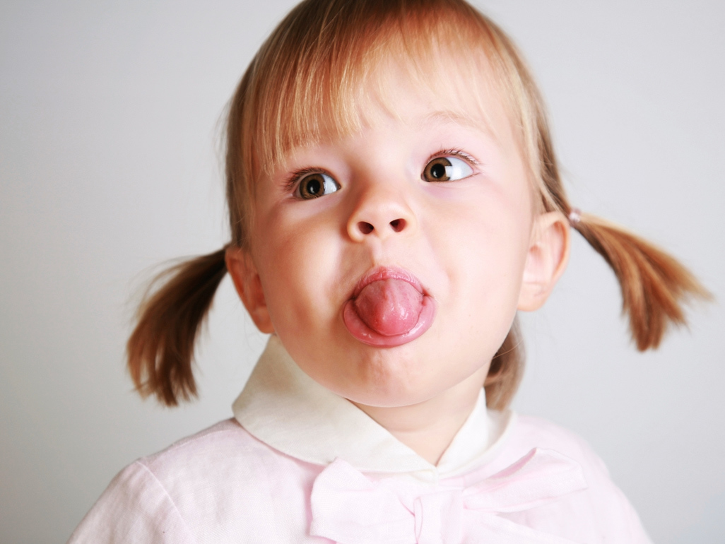 little girl sticking her tongue out