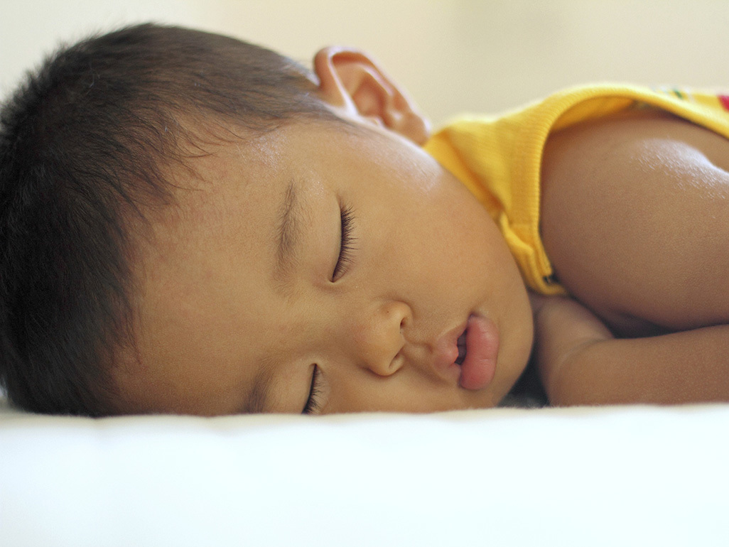 A child sleeping on their stomach