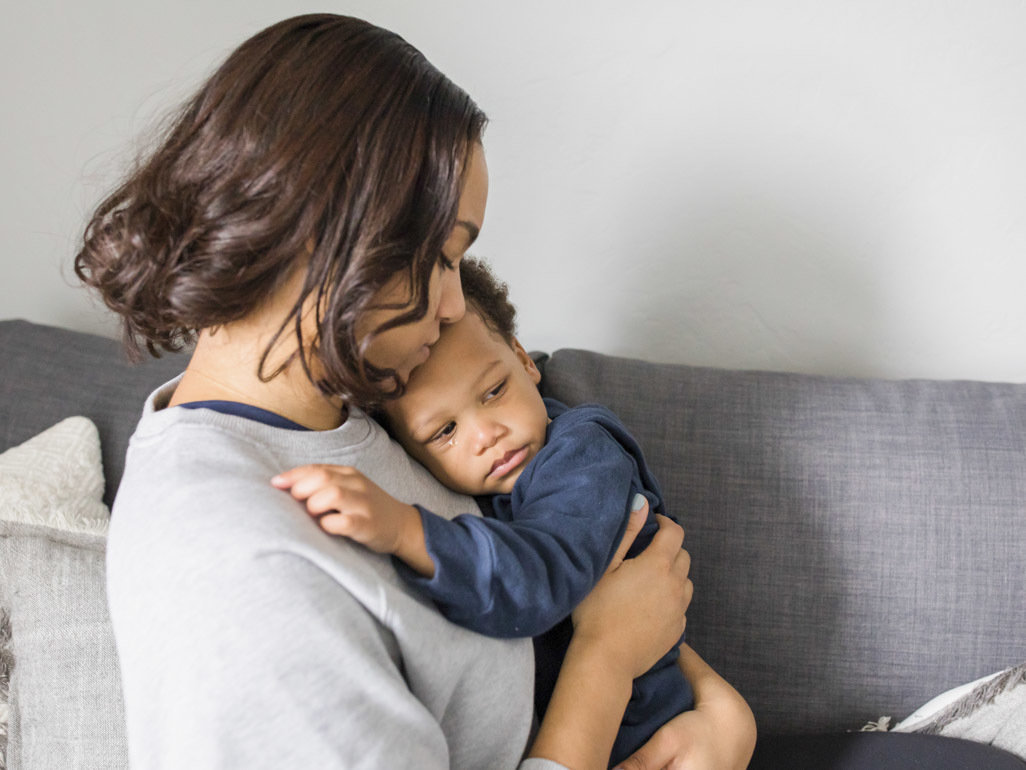 mom soothing her sick toddler 