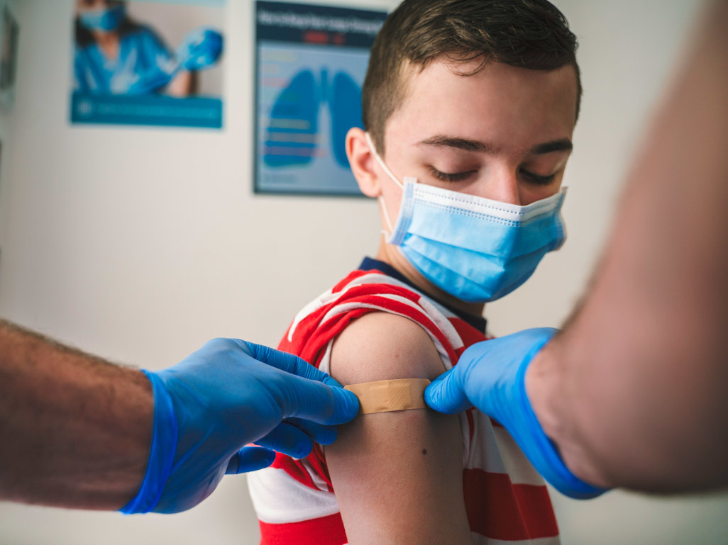 child getting a bandaid after vaccine shot