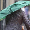 A pedestrian walks down Clement Street during a rainstorm in San Francisco, Calif. on January 11, 2022.