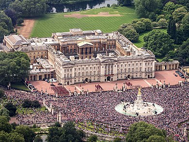Aerial view of the palace with crowds outside celebrating Elizabeth II's official 90th birthday