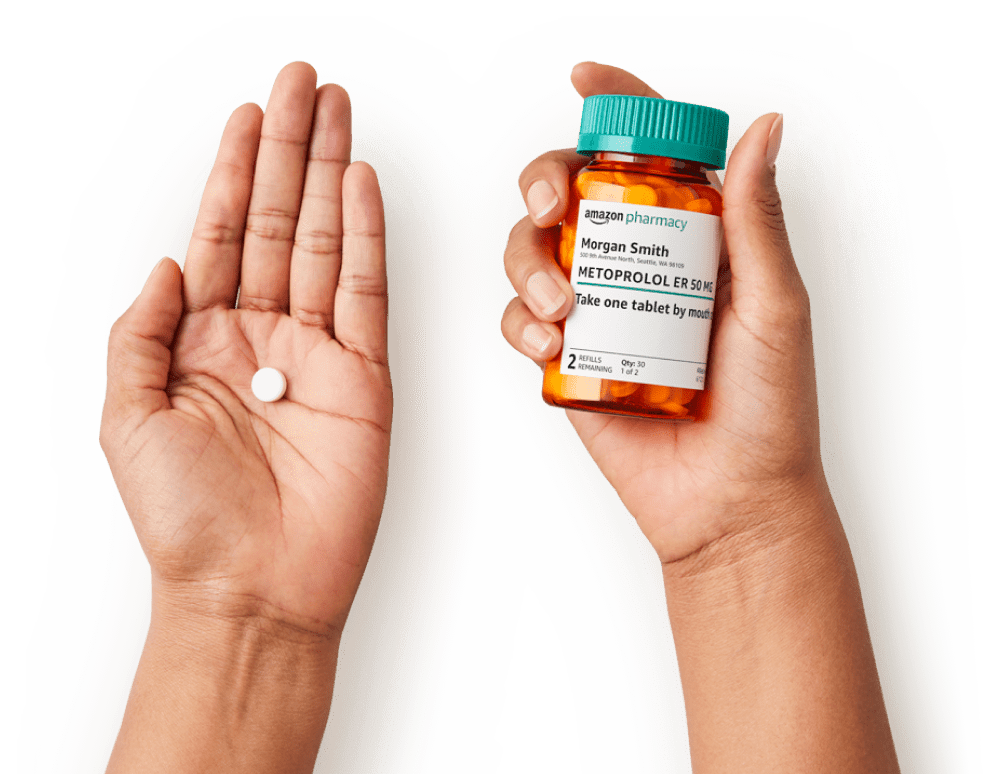 hands holding a pill and an Amazon Pharmacy bottle