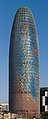 Image 13 Torre Agbar Photo credit: Diliff The Torre Agbar is a landmark skyscraper and the third tallest building in Barcelona, Spain. It was designed by French architect Jean Nouvel, who stated that the shape of the Torre Agbar was inspired by the mountains of Montserrat that surround Barcelona, and by the shape of a geyser of water rising into the air. Its design combines a number of different architectural concepts, resulting in a striking structure built with reinforced concrete, covered with a facade of glass, and over 4,500 window openings cut out of the structural concrete. More selected pictures