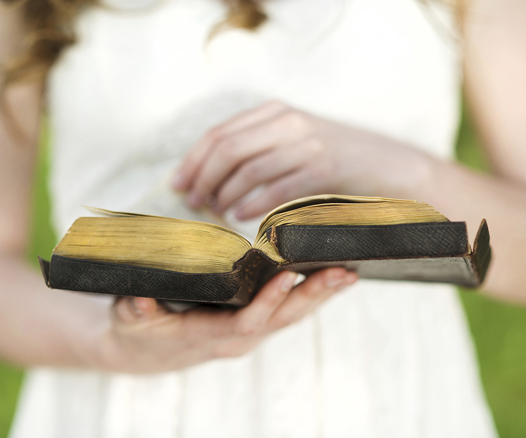 A woman holding a Bible