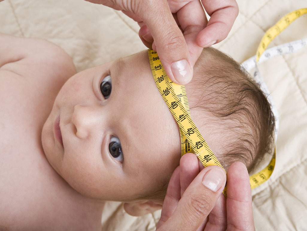 baby's head measured with a tape measure