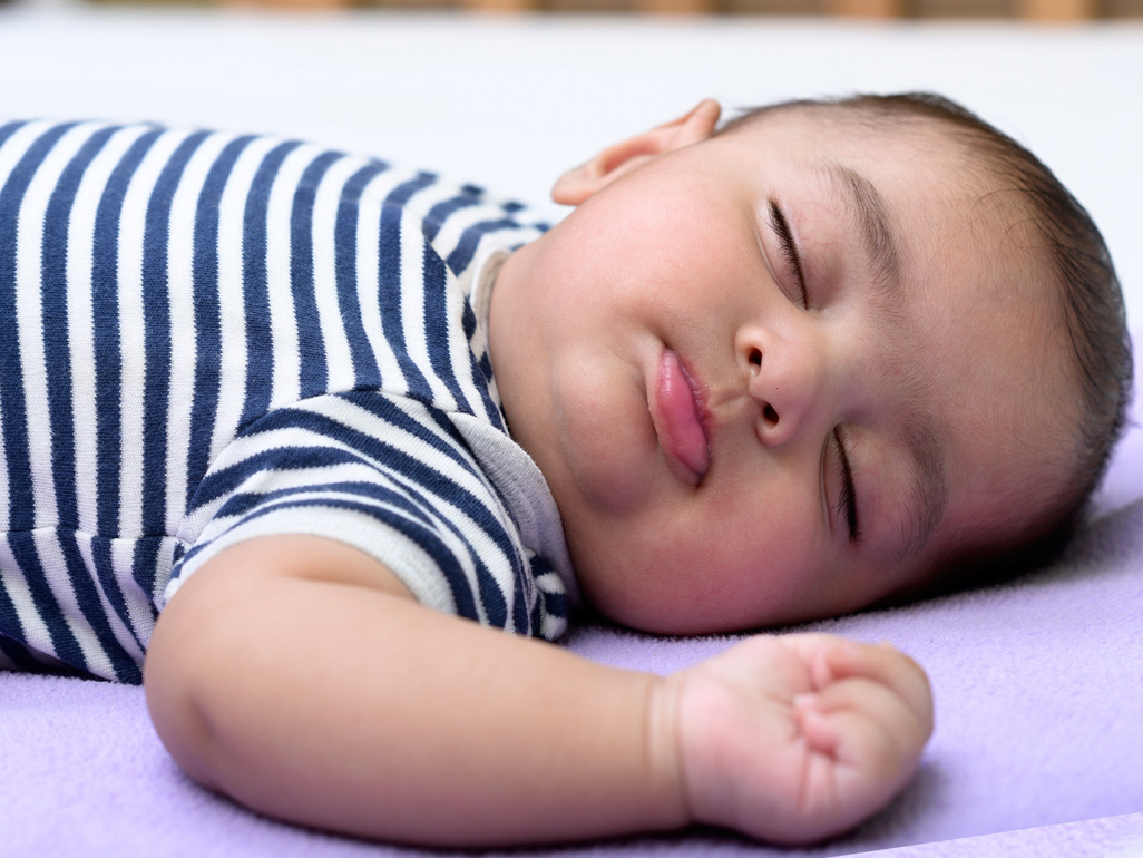 baby sleeping on his back