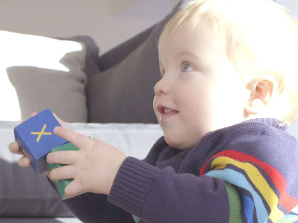 child holding blocks