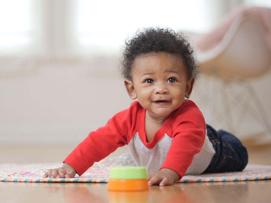 baby on tummy smiling