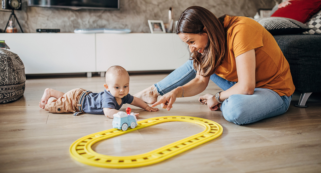 baby on the floor playing with mom