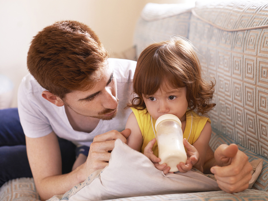 A child drinking milk from a bottle