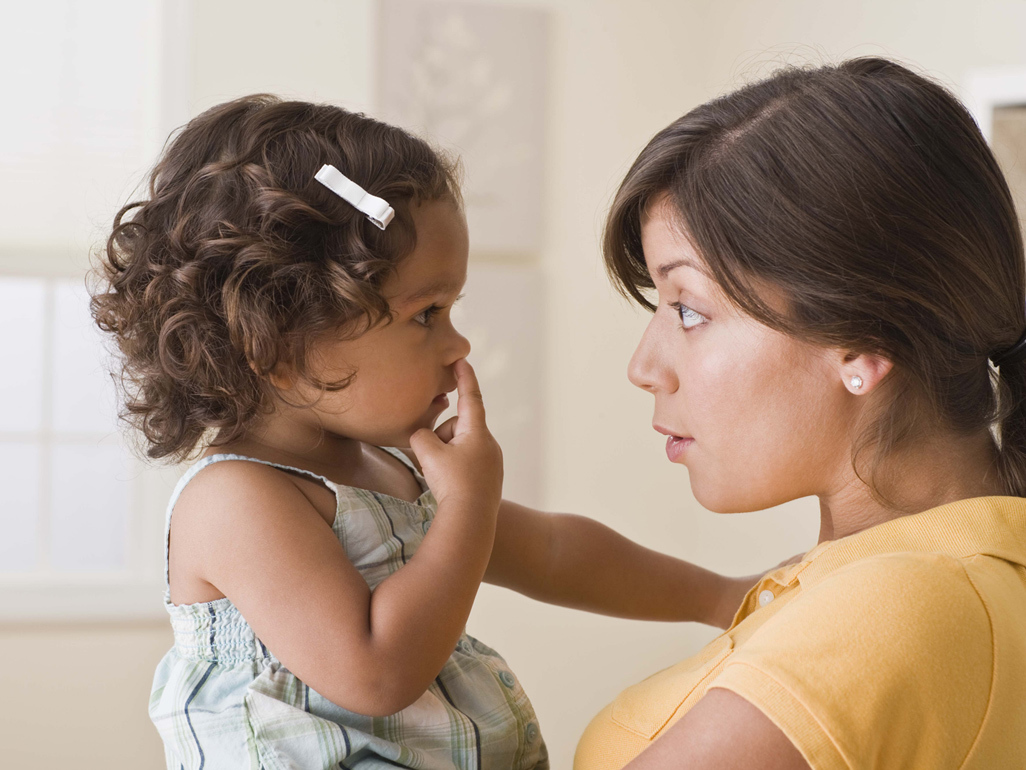 mother holding her daughter and talking to her