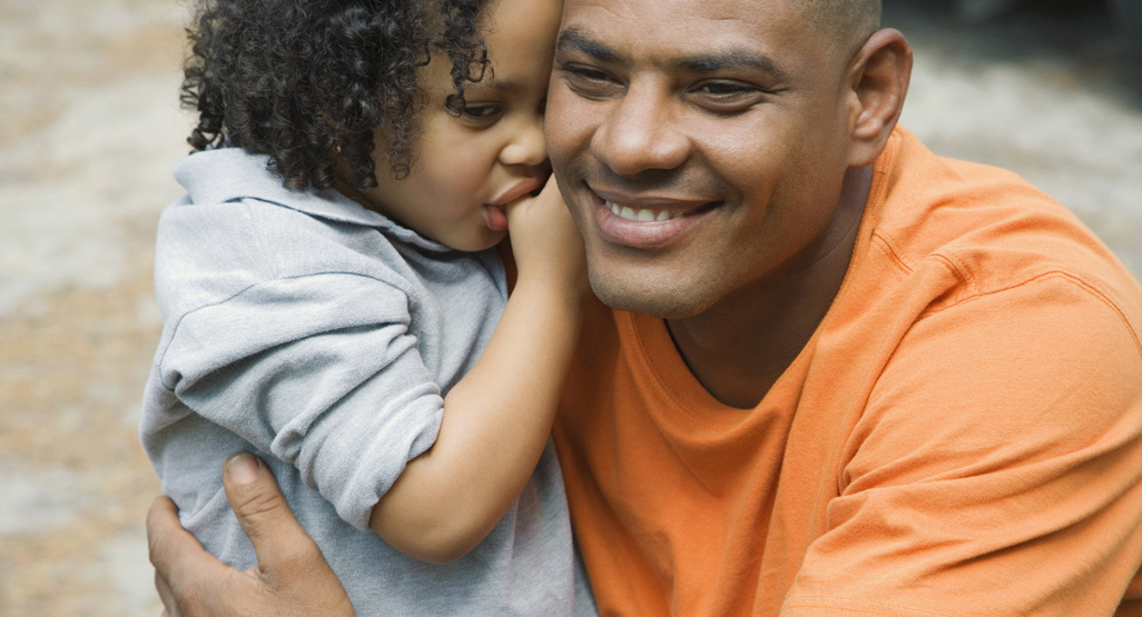 dad hugging little girl who is leaning into his neck