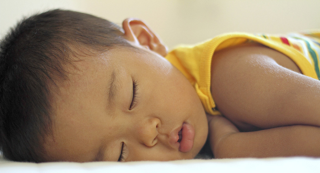 A child sleeping on their stomach