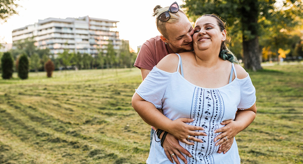 Pregnant woman getting a hug from partner