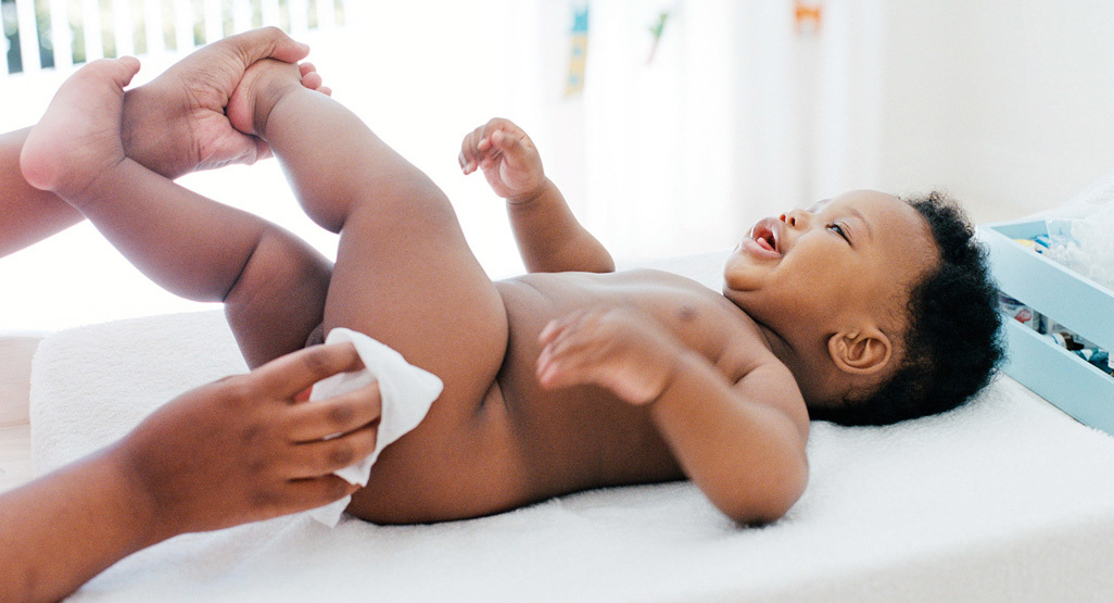 happy baby having diaper changed