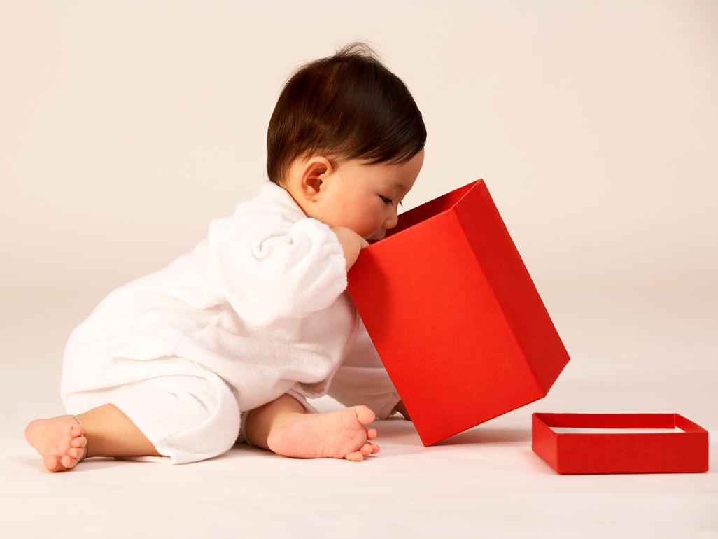 baby playing with red box