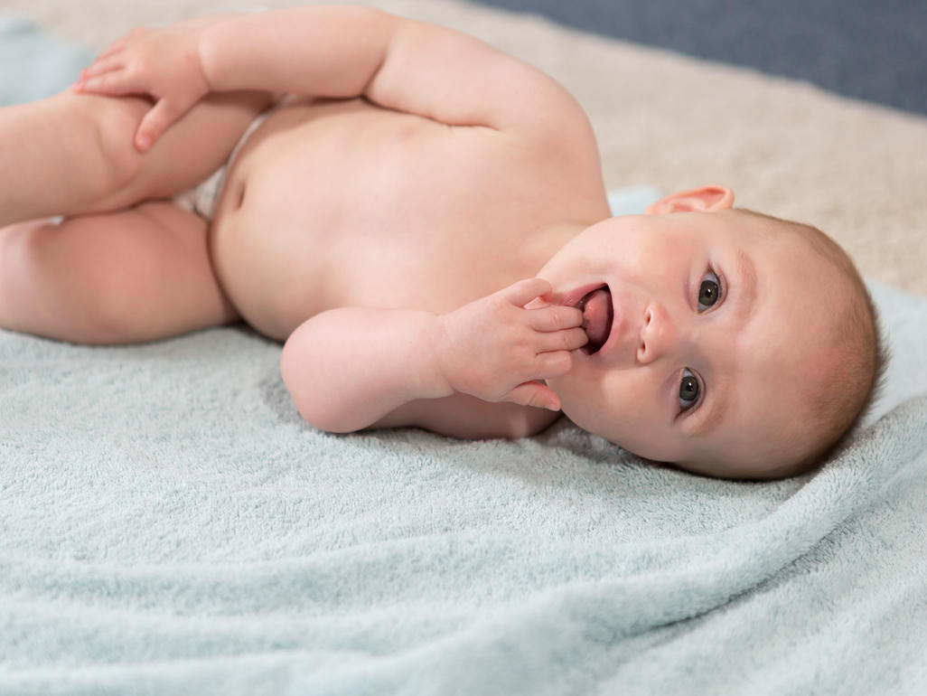 Happy baby lying on a towel