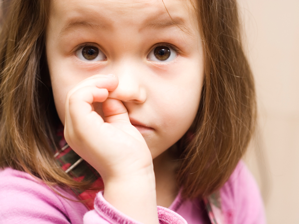 girl picking her nose