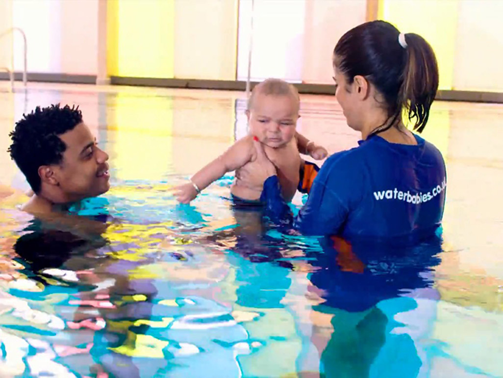 Waterbabies teacher holding baby in swimming pool