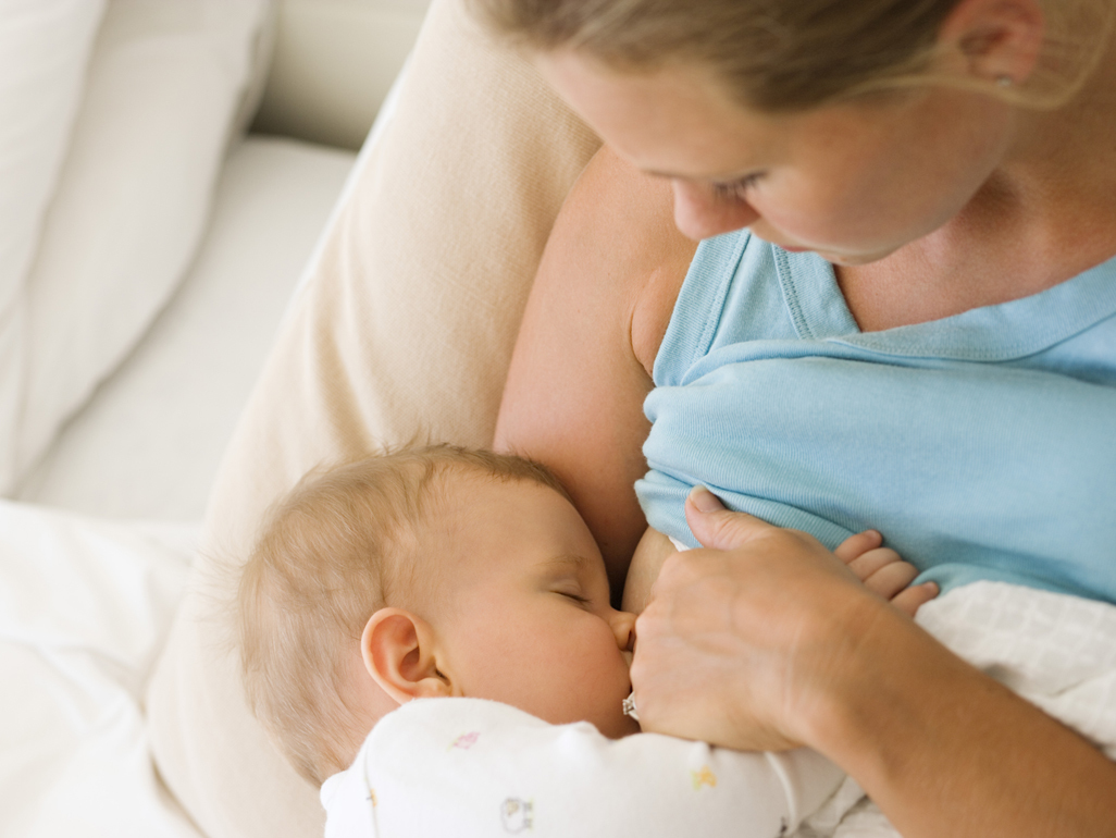 Mum breastfeeding baby in bed