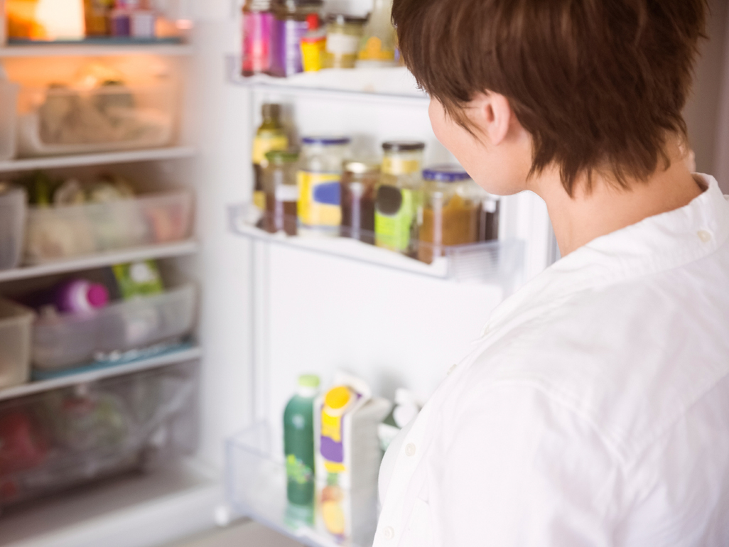 Woman looking in a fridge