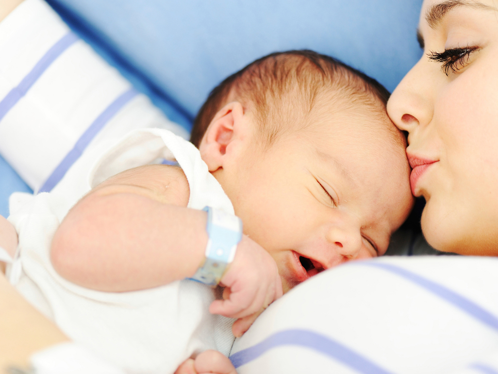 Woman holding her 2 days old newborn baby