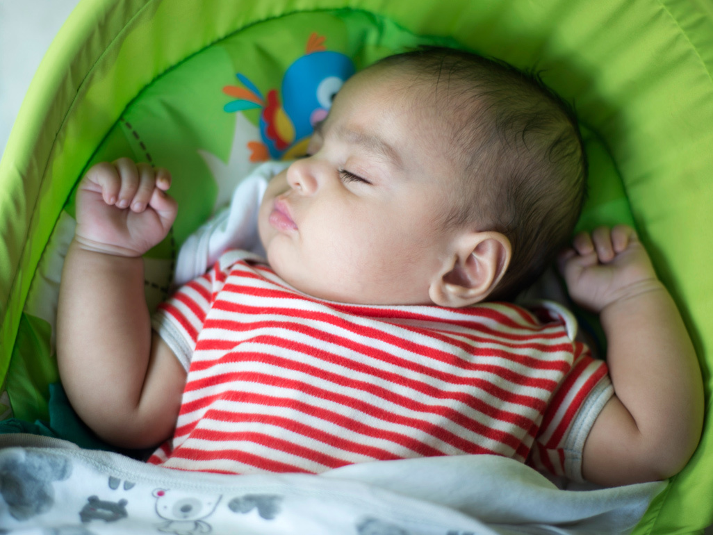 Sleeping baby in stripy red top